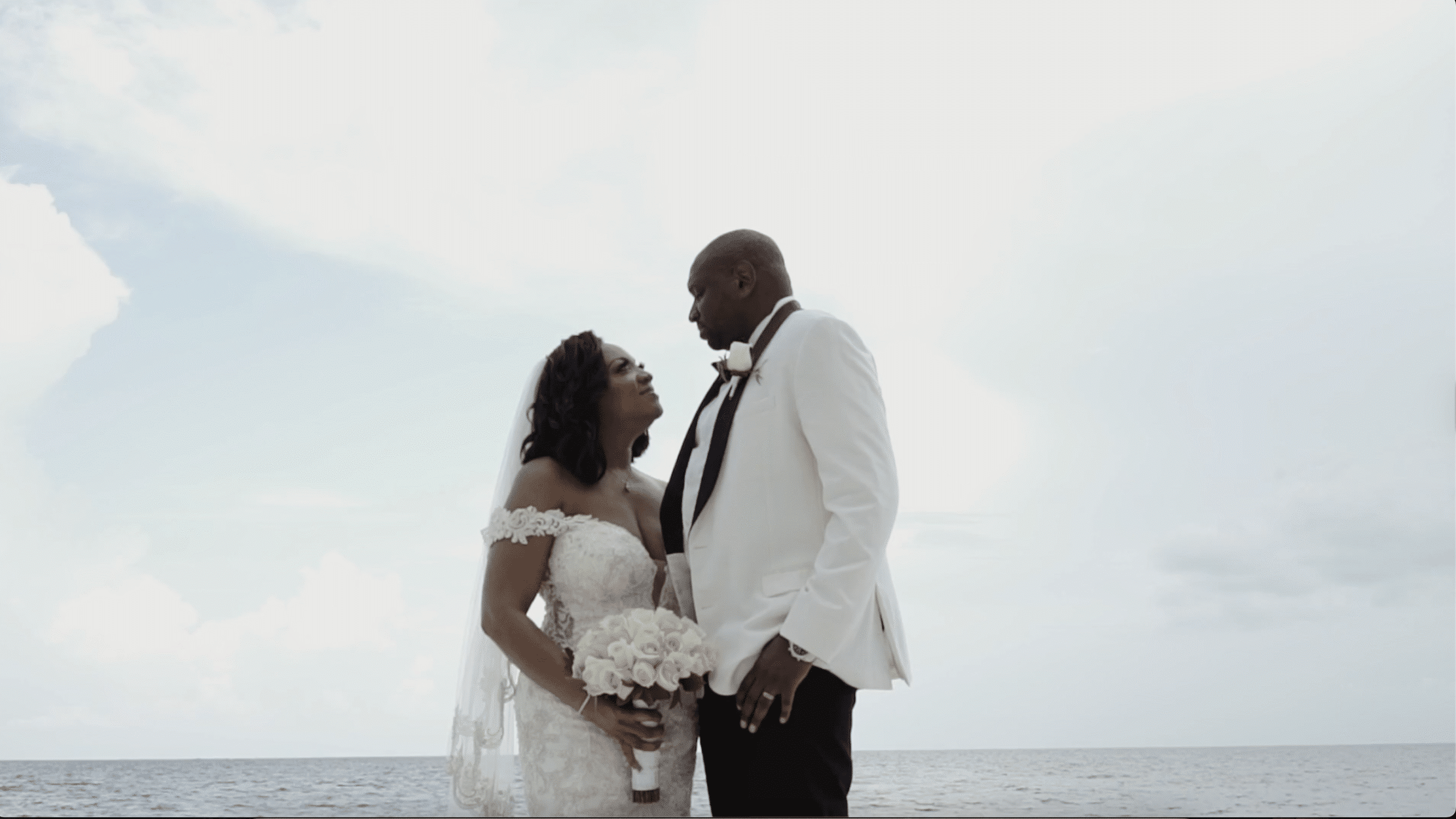 Bride and groom overlooking the ocean during their Atelier Playa Mujeres destination wedding planned by Precious Nuptials and Destinations.