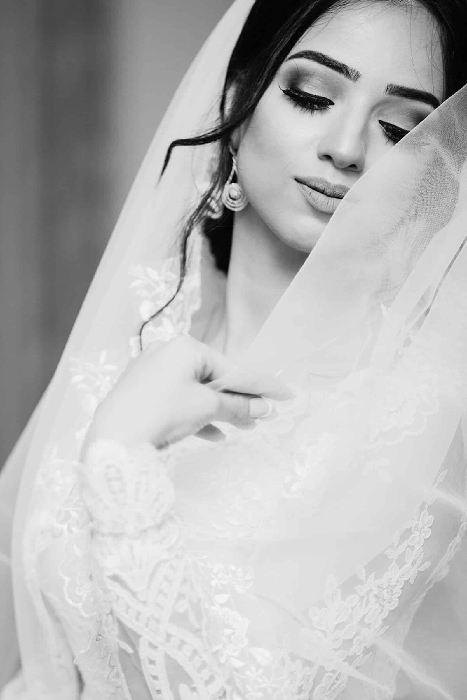 Elegant bride adjusting her veil before the ceremony — Houston destination wedding planning and coordination by Precious Nuptials.